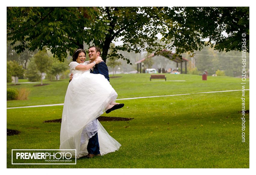 Bride and groom dancing in the rain