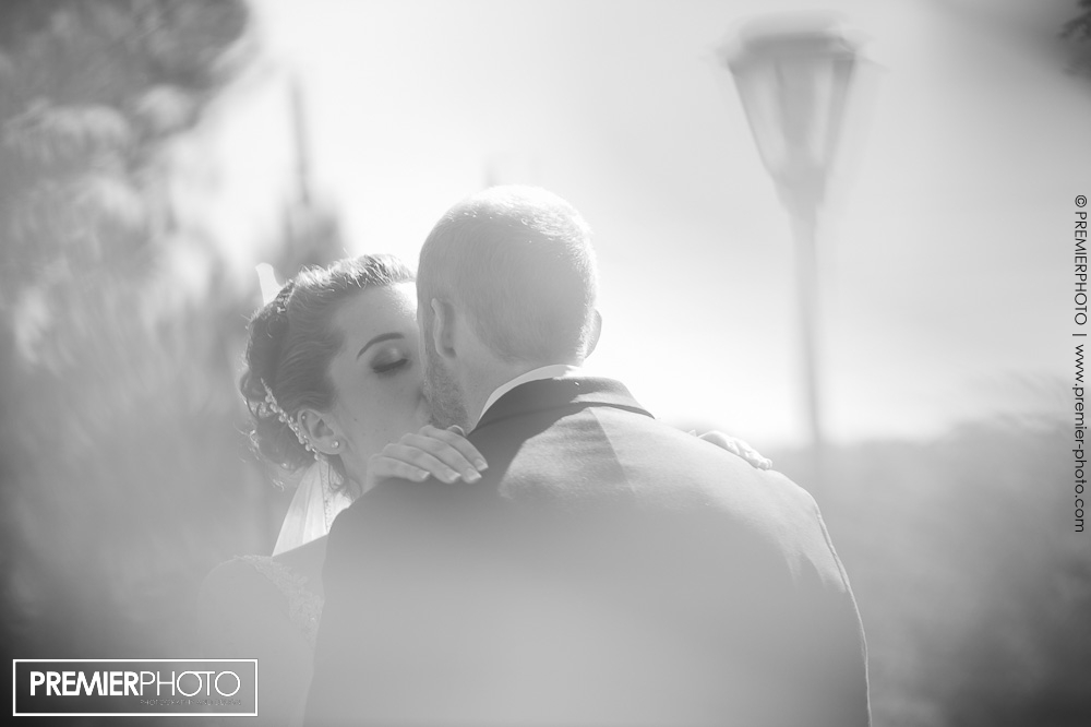 Soft photojournalistic style portrait of bride kissing her groom
