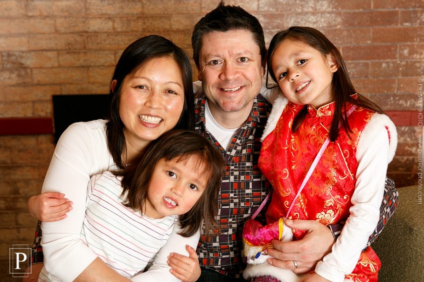 MIxed family of Chinese and American having a casual and relaxed portrait in the intimacy of their home